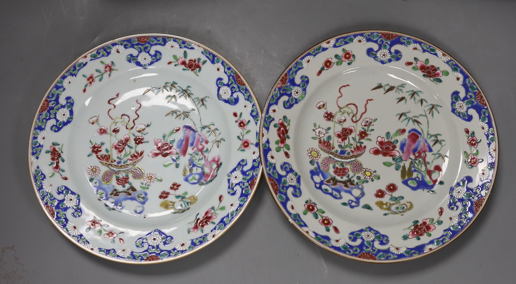 A Set of three 18th century Chinese export famille rose plates and a similar dish, largest 22.5cm diameter